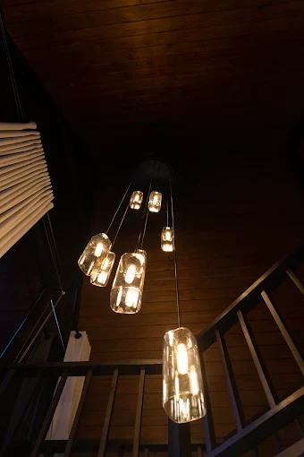 Cascade of glass pendant lights in the timber stairwell