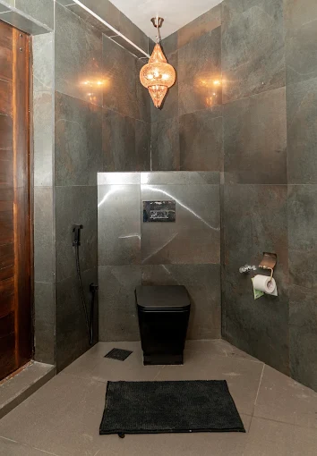 Slate-tiled washroom with a Moroccan pendant lamp